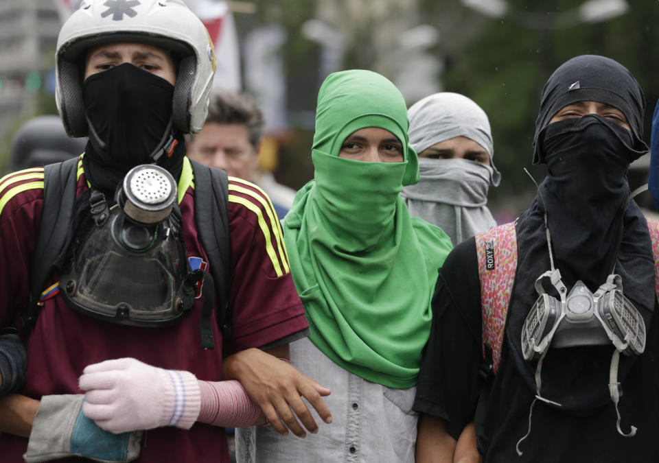 Opponents to Venezuela's President Nicolas Maduro march in Caracas, Venezuela, Saturday, May 4, 2019. Opposition leader Juan Guaido called his supporters for a mobilization outside military installations to press the armed forces to support his bid to remove Maduro from power. (AP Photo/Martin Mejia)