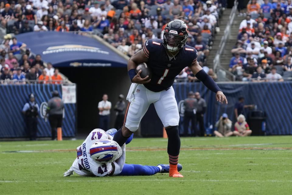 Chicago Bears quarterback Justin Fields (1) is tackled by Buffalo Bills' Christian Benford (47) during the first half of an NFL preseason football game, Saturday, Aug. 26, 2023, in Chicago. (AP Photo/Nam Y. Huh)