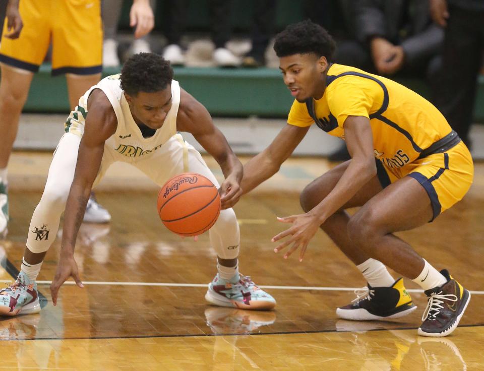 St. Vincent-St. Mary's Torell Hopson II steals the ball from Cleveland St. Ignatius' Calvin Little on Thursday night at LeBron James Arena. The Irish won the game 56-38. [Phil Masturzo/Beacon Journal]