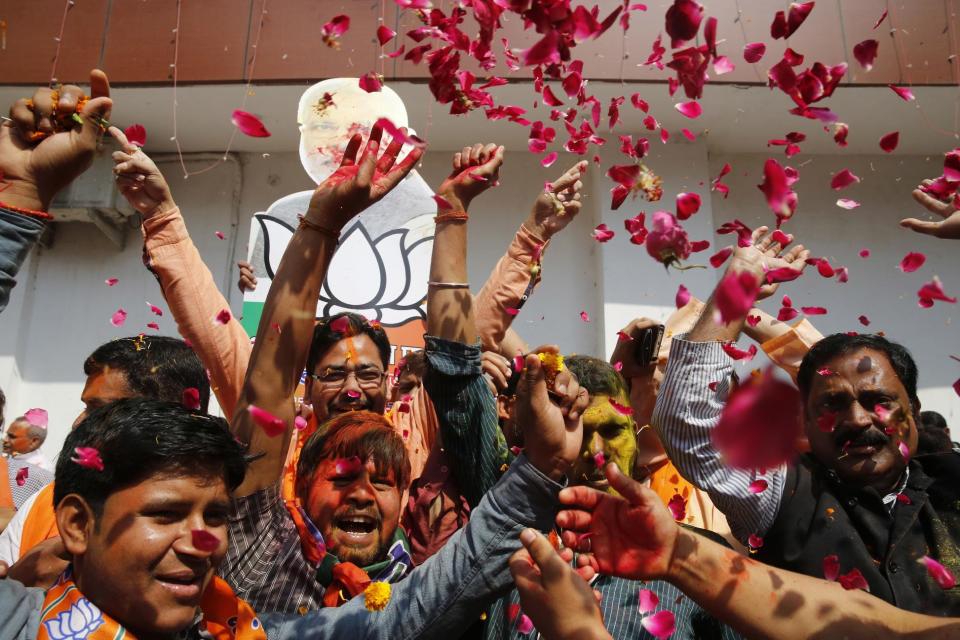 Bharatiya Janata Party supporters celebrate winning seats in the state legislature during elections in Utar Pradesh, Lucknow, India, Saturday, March 11, 2017. India's governing Hindu nationalist party is heading for major victories in key state legislature elections that are seen as a referendum on Prime Minister Narendra Modi's nearly 3-year-old rule. (AP Photo/Rajesh Kumar Singh)