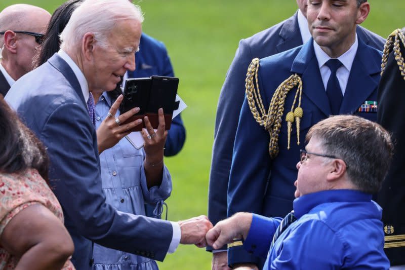 President Joe Biden fist bumps with a guest at the 33rd anniversary celebration of the Americans with Disabilities Act on Monday on the South Lawn at the White House in Washington, D.C. Biden called the law a "source of opportunity, meaningful inclusion, respect and dignity." Photo by Jemal Countess/UPI