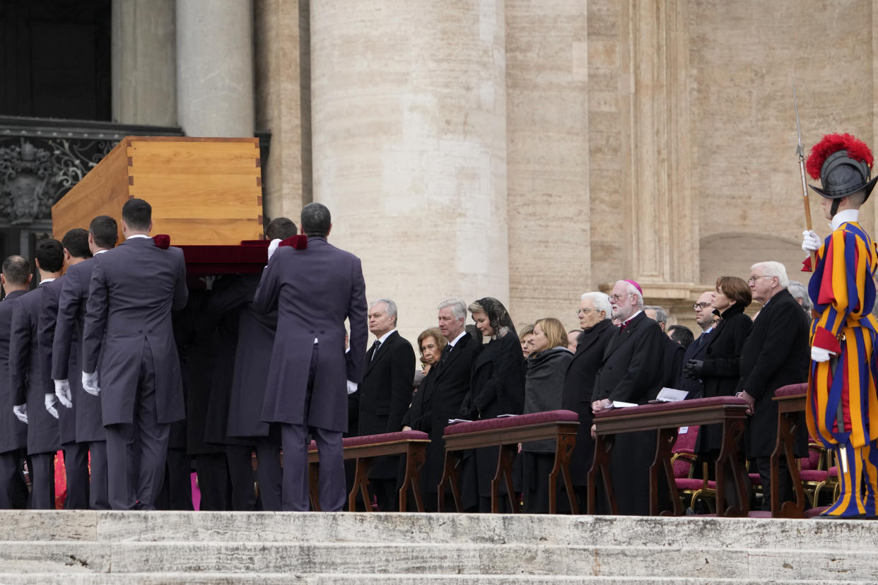 Dignitaries watch as the coffin of late Pope Emeritus Benedict XVI is carried away after a funeral mass in St. Peter's Square at the Vatican, Thursday, Jan. 5, 2023. (AP Photo/Andrew Medichini)