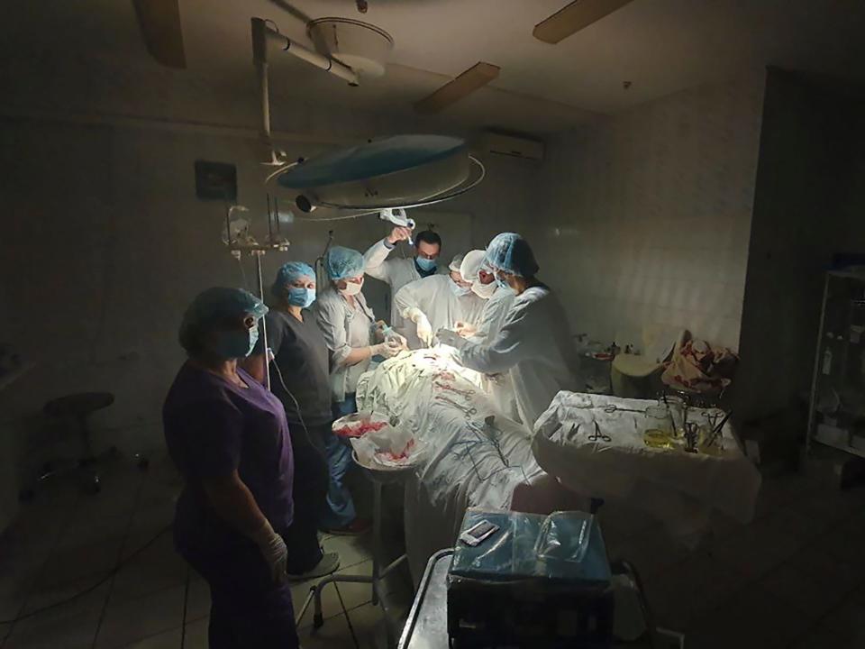 This photo mad available by Ukrainian doctor Oleh Duda shows the moment when lights at a hospital went out as he was performing complicated, dangerous surgery on a bleeding patient at the hospital in western city of Lviv, Ukraine, Tuesday, Nov. 15, 2022. Russia's devastating strikes on Ukraine's power grid have strained and disrupted the country’s health care system, already battered by years of corruption, mismanagement, the COVID-19 pandemic and nine months of war.