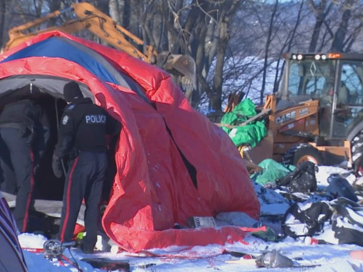 Fredericton police were monitoring work being done Friday morning to clear out a tent camp near Government House on Fredericton's south side. (Ed Hunter/CBC - image credit)