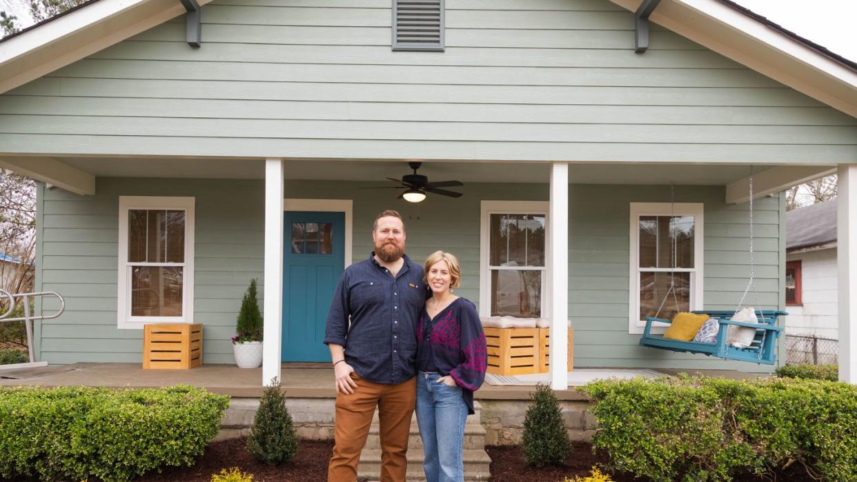 hosts ben and erin napier in front of the hollingsworth house on reveal day