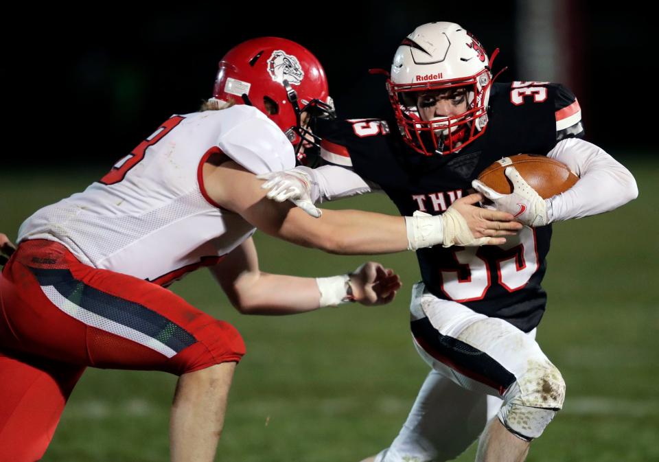 Seymour High School senior Carson Molle (35) runs for a gain after a catch against New London during their Bay Conference football game Oct. 30 in Seymour.