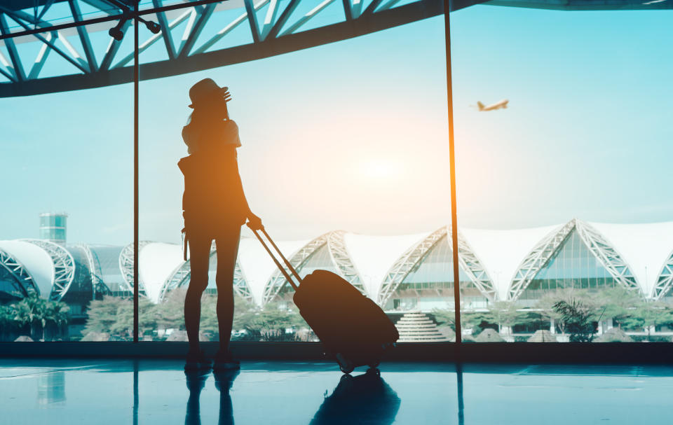 Silhouette woman travel with luggage. (PHOTO: Getty Images)