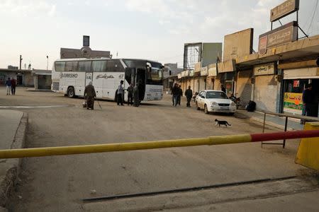 Passengers wait in Qamishli city in Syria's Kurdish-held northeast to embark on a bus headed for government-controlled Aleppo, Syria May 7, 2017. REUTERS/Rodi Said