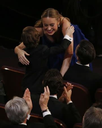 Brie Larson hugs co-star Jason Tremblay as she takes the stage to accept the Oscar for Best Actress for her role in "Room" at the 88th Academy Awards in Hollywood, California February 28, 2016. REUTERS/Mario Anzuoni