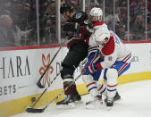 Arizona Coyotes' Lawson Crouse (67) gets pinned up against the boards by Montreal Canadiens' Brett Kulak (77) and Ben Chiarot (8) during the first period of an NHL hockey game Monday, Jan. 17, 2022, in Glendale, Ariz. (AP Photo/Darryl Webb)