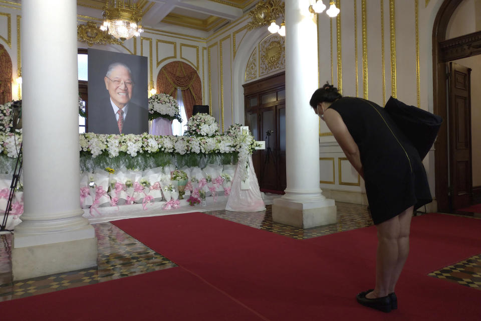 A mourner pays her respects at a memorial for former Taiwanese President Lee Teng-hui in Taipei, Taiwan, Saturday, Aug. 1, 2020. Lee, who brought direct elections and other democratic changes to the self-governed island despite missile launches and other fierce saber-rattling by China, died on Thursday at age 97. (AP Photo/Chiang Ying-ying)