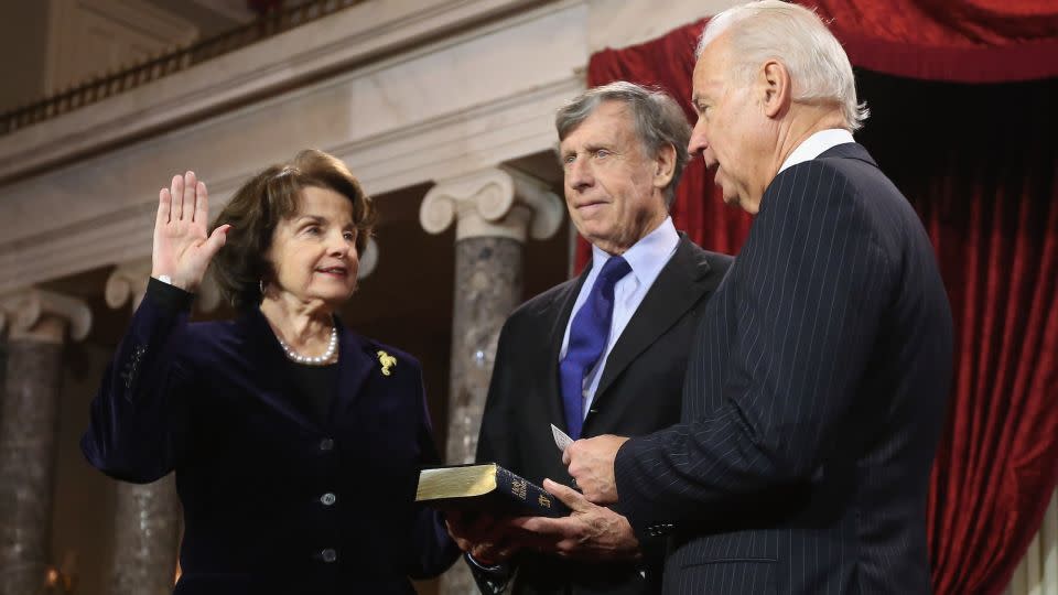 Sen. Dianne Feinstein participates in a reenacted swearing-in with her husband Richard C. Blum and then-Vice President Joe Biden in the Old Senate Chamber at the U.S. Capitol January 3, 2013 in Washington, DC. - Chip Somodevilla/Getty Images