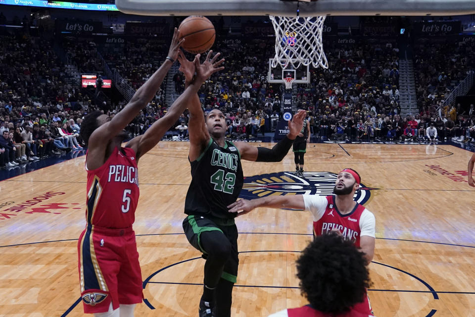 Boston Celtics center Al Horford (42) battles under the basket with New Orleans Pelicans forward Herbert Jones (5) in the first half of an NBA basketball game in New Orleans, Friday, Nov. 18, 2022. (AP Photo/Gerald Herbert)