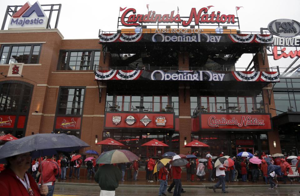 Fans gather outside the new Ballpark Village entertainment complex across the street from Busch Stadium before the start of a baseball game between the St. Louis Cardinals and the Cincinnati Reds Monday, April 7, 2014, in St. Louis. (AP Photo/Jeff Roberson)