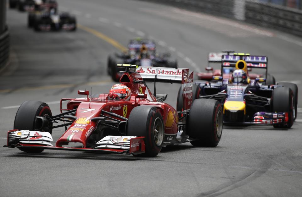 Ferrari Formula One driver Kimi Raikkonen of Finland leads Red Bull Daniel Ricciardo of Australia during the Monaco Grand Prix in Monaco May 25, 2014. REUTERS/Max Rossi (MONACO - Tags: SPORT MOTORSPORT F1)