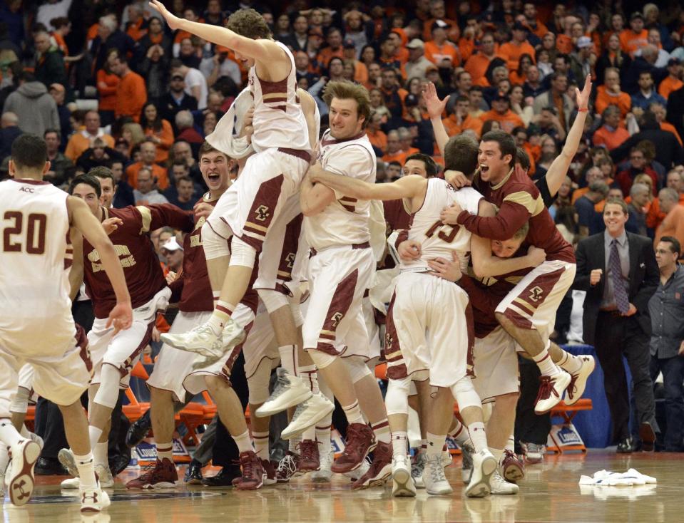 Boston College players celebrate after defeating Syracuse 62-59 in overtime in an NCAA college basketball game in Syracuse, N.Y., Wednesday, Feb. 19, 2014. (AP Photo/Kevin Rivoli)