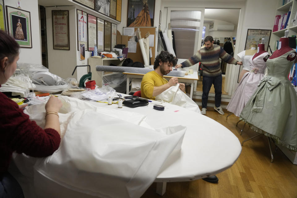 Dressmakers work at the Tirelli Atelier in Rome, Tuesday, March 5, 2024. For nearly six decades, the Tirelli atelier in Rome has woven itself into the fabric of Italian and international film history, earning the nickname the "Oscar tailor's shop" for its contribution to cinematic costume design. Established in November 1964, the shop on a quiet Roman street has been behind 17 Academy Awards for Best Costume Design. (AP Photo/Gregorio Borgia)