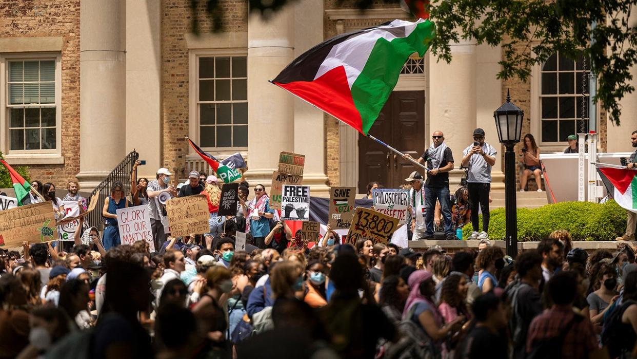 Protesters with a Palestinian flag