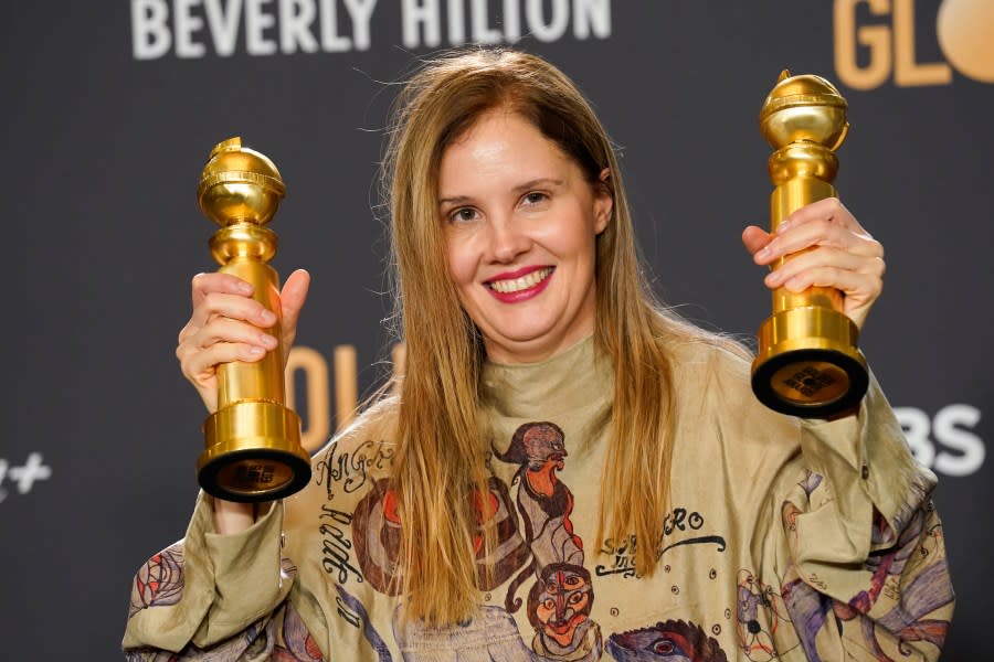 Justine Triet poses with the awards for best screenplay, motion picture for “Anatomy of a Fall” and for best motion picture, foreign language for “Anatomy of a Fall” in the press room at the 81st Golden Globe Awards on Sunday, Jan. 7, 2024, at the Beverly Hilton in Beverly Hills, Calif. (AP Photo/Chris Pizzello)