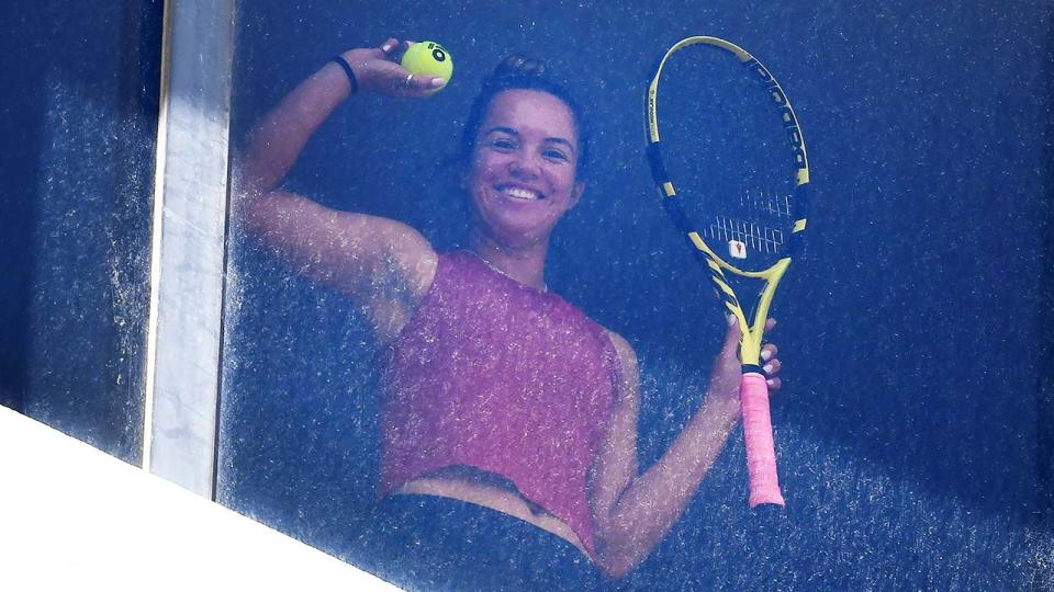 An unidentified tennis player, pictured here looking out from their hotel room in Melbourne.