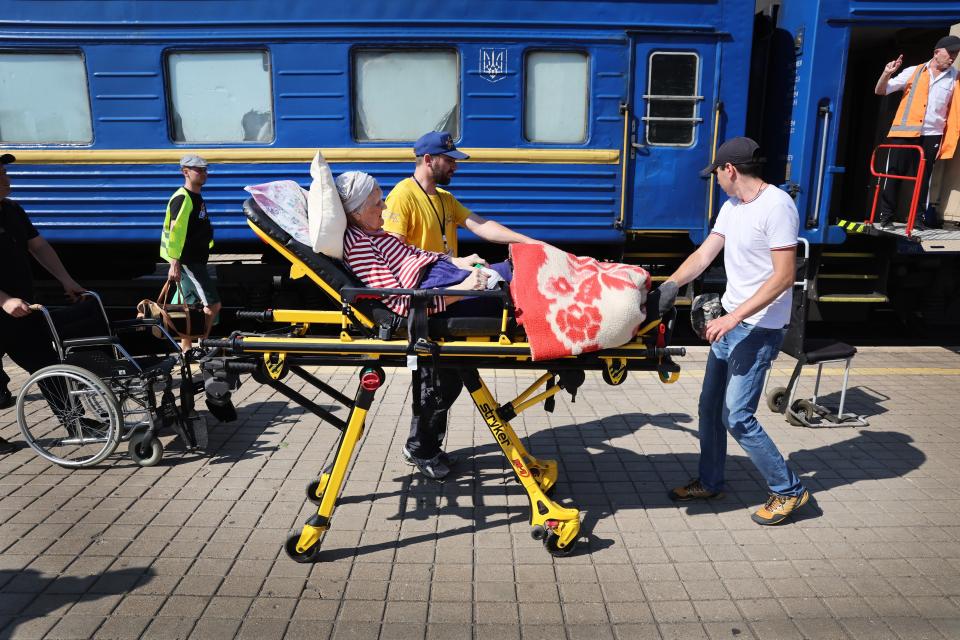 An elderly woman is helped onto a train which is taking evacuees trying to escape the front-line war with Russia in Pokrovsk, Ukraine (Getty Images)