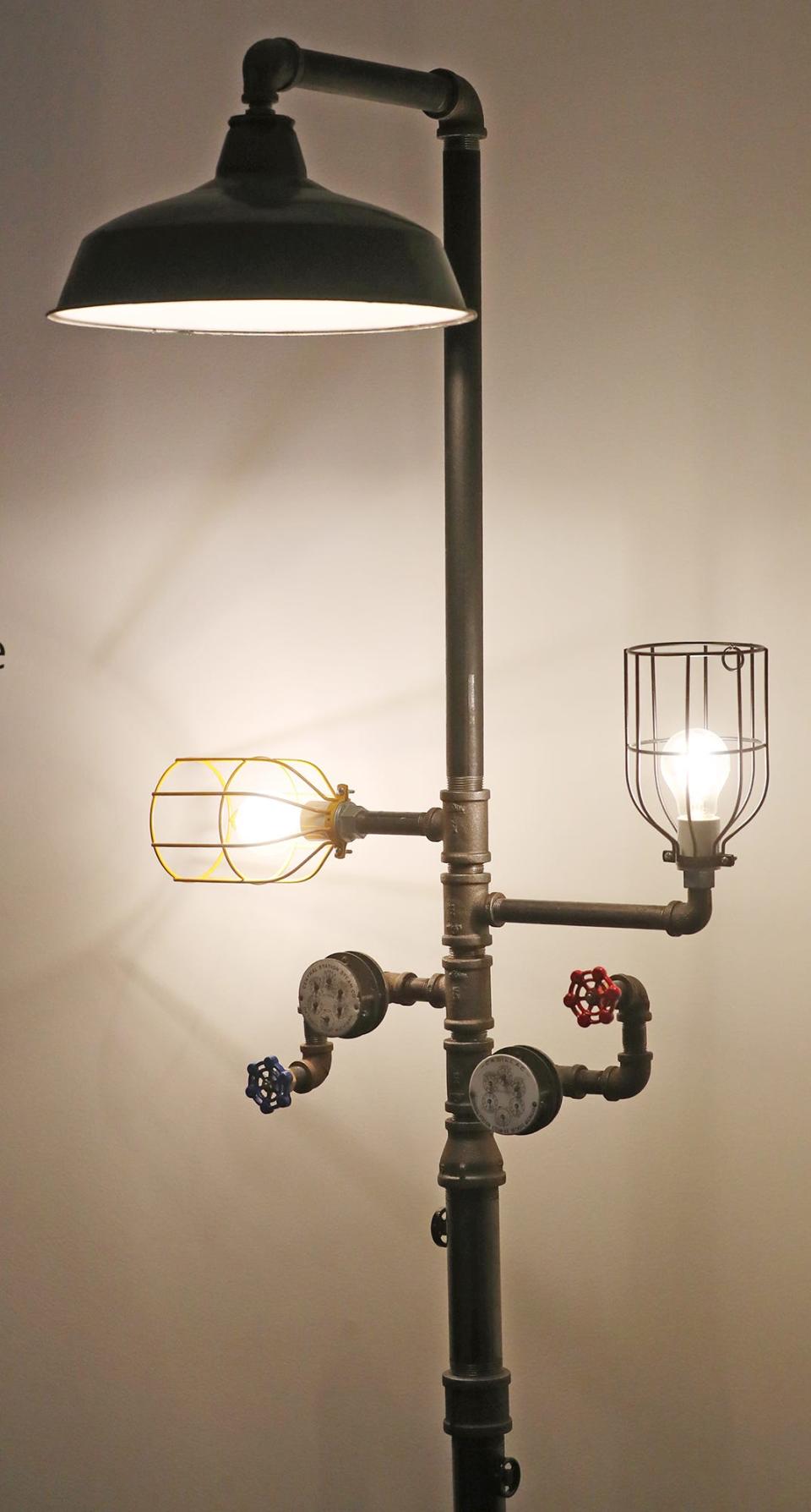 A lamp made from new pipe and items repurposed from steam plant artifacts salvaged from the old B.F. Goodrich power plant at Bounce Innovation Hub in Akron.