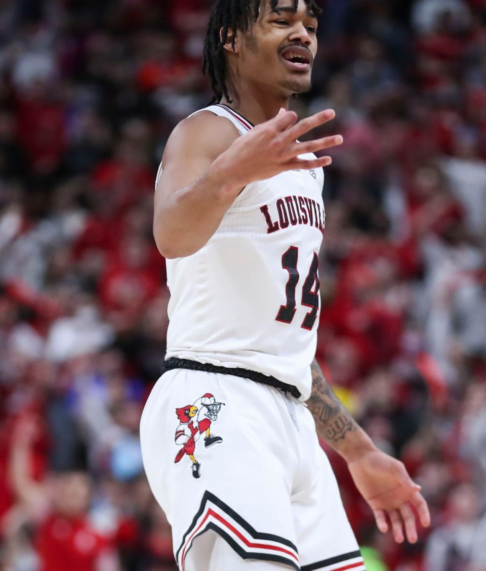 Louisville 's Dre Davis signals three in the second half as he helped the Cards tie up Duke in the second half. Davis finished with 16 points. The Cards fell 74-65 to visiting Duke. January 29, 2022