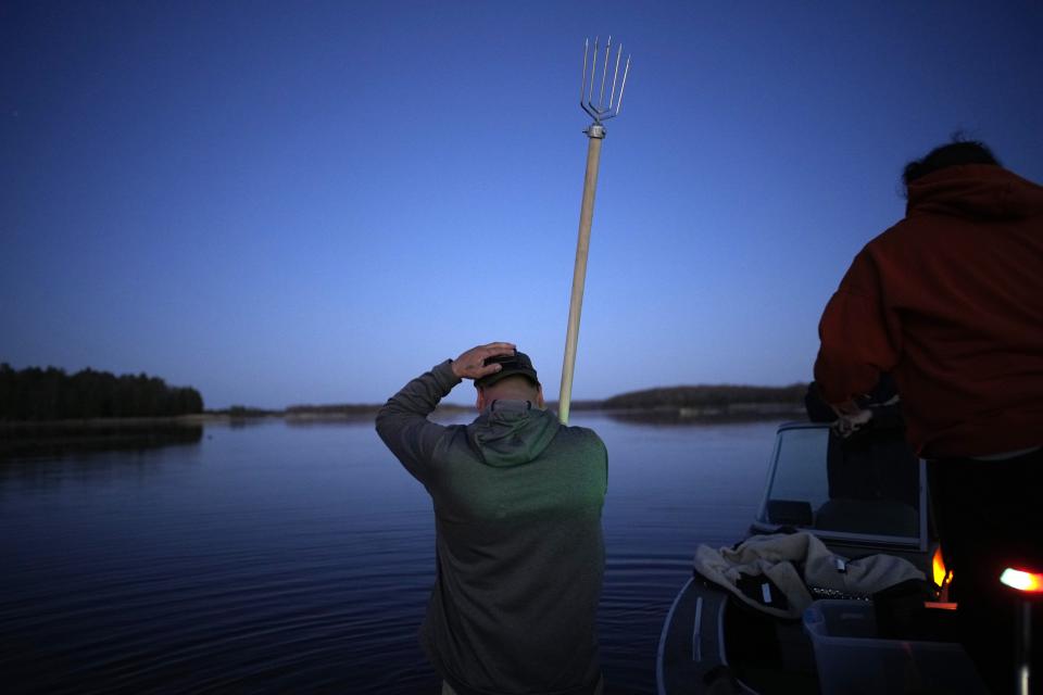 John Baker holds a spear while getting ready to fish at the Chippewa Flowage on the Lac Courte Oreilles Reservation, Sunday, April 14, 2024, near Hayward, Wis. (AP Photo/John Locher)