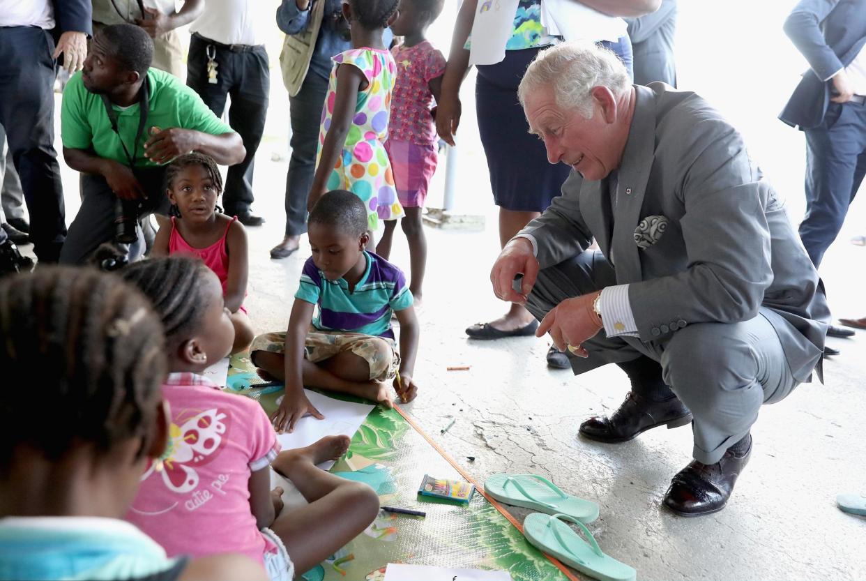 The Prince of Wales meets a group of displaced Barbudan children: Getty Images