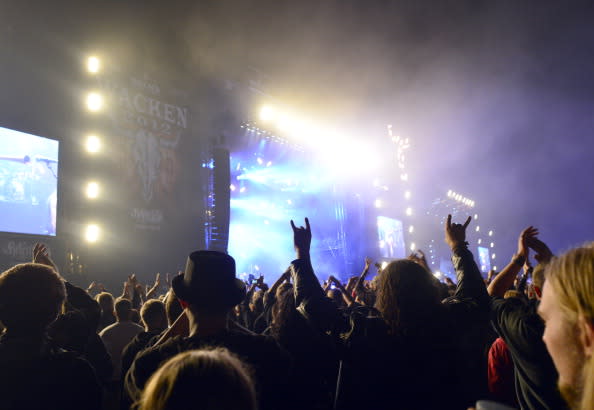 Visitors attend the Wacken Open Air heavy metal music fest on August 3, 2012 in Wacken, Germany. Approximately 75,000 heavy metal fans from all over the world have descended on the north German village of 1,800 residents for the annual three-day fest. (Photo by Patrick Lux/Getty Images)