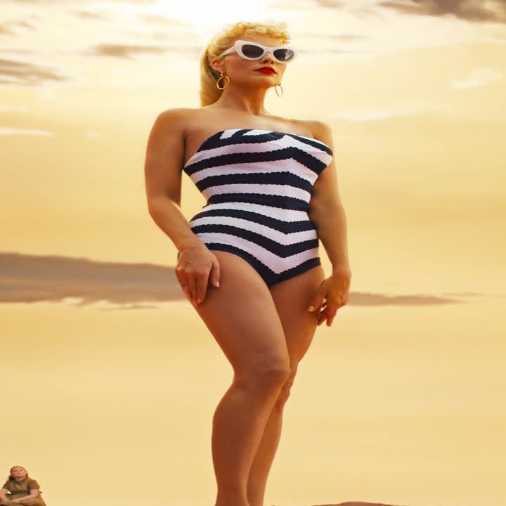 Margot as Barbie wearing a striped strapless bathing suit