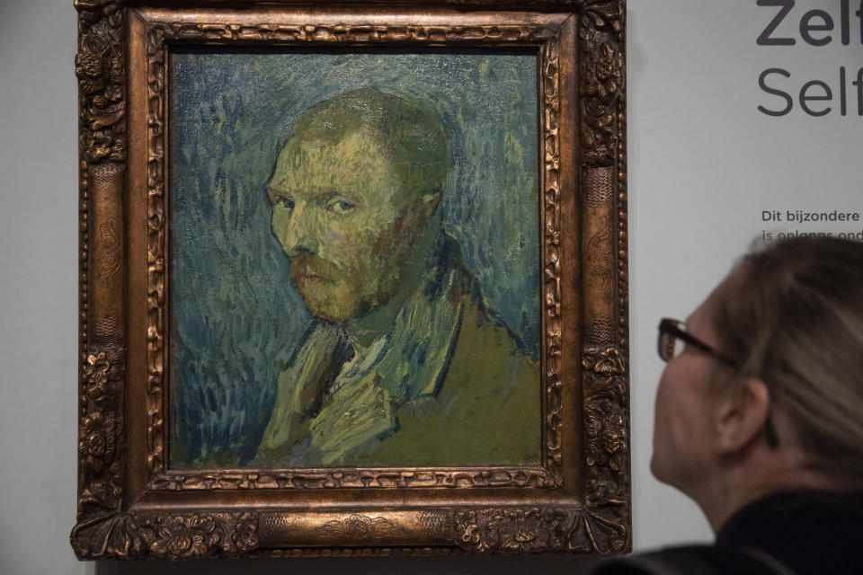 A journalist takes a closer look at the previously contested painting by Dutch master Vincent van Gogh, a 1889 self-portrait, of which the authenticity was confirmed during a press conference in Amsterdam, Netherlands, Monday, Jan. 20, 2020. The painting, which belongs to the National Museum in Norway, was painted at the Saint-Paul de Mausole psychiatric institution in Saint-Remy de Provence, France. (AP Photo/Peter Dejong)