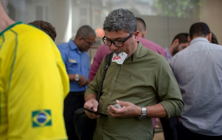 Dozens of adults huddle at the makeshift Panini sticker trading marketplaces in Rio, clutching a wad of cards they hope to swap and a list of the ones they need