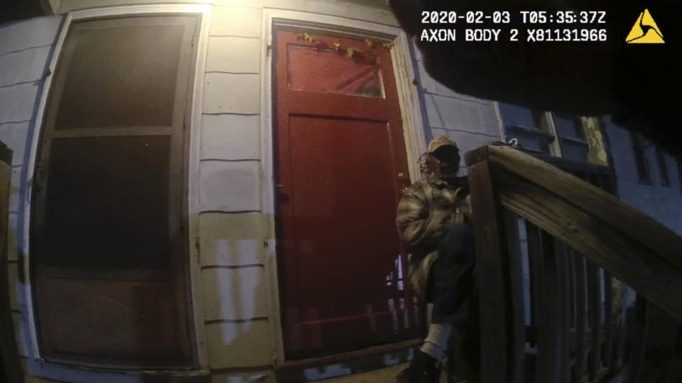 In this image from Birmingham Police Department body-camera video, Carl Grant sits on the porch of a stranger’s home in Birmingham, Ala., after police were called there on Feb. 2, 2020. Grant, a Vietnam War veteran with dementia, went out to shop for groceries near his suburban Atlanta home but became disoriented and ended up driving over two hours away. Police were called when he tried to get inside houses in Birmingham that he thought were his. (Birmingham Police Department via AP)