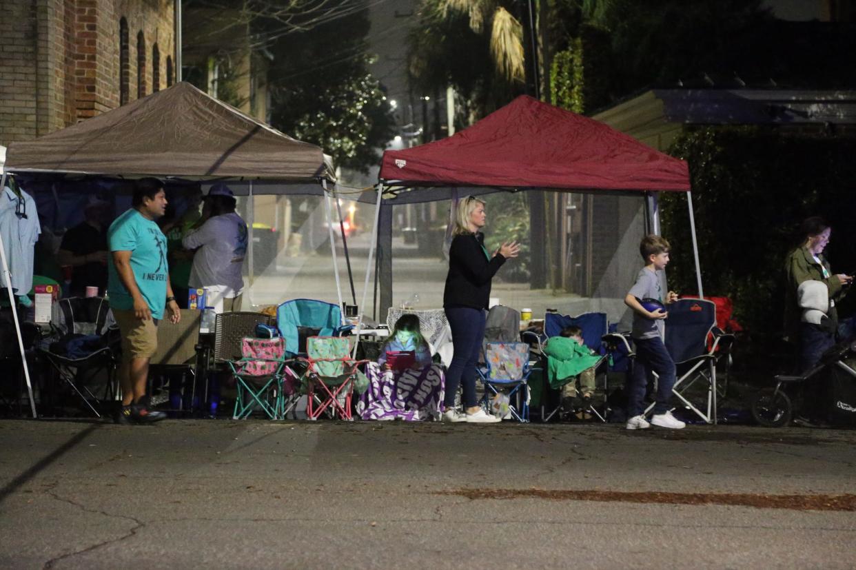 Revelers set up in the early morning hours along the parade route.