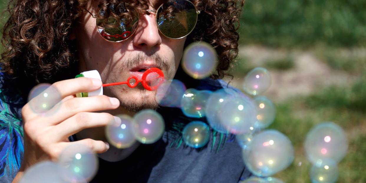 An activist blows smoke bubbles during an event to raise awareness for bladder cancer outside the European Parliament in Brussels, Belgium May 29, 2017.