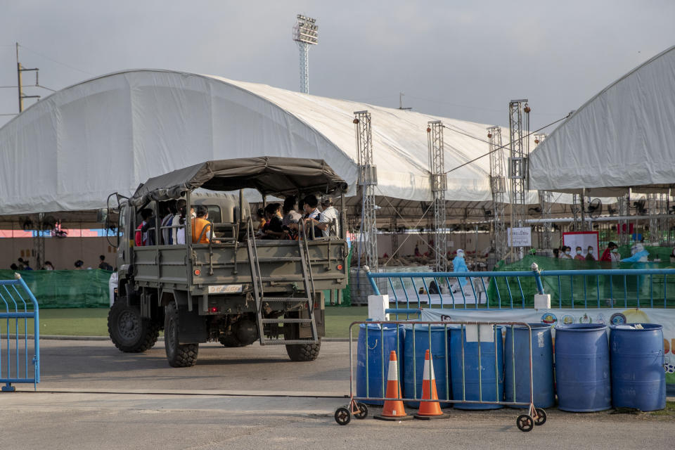 A truck carrying migrant workers and their families arrives at a field hospital for COVID-19 patents in Samut Sakhon, South of Bangkok, Thailand, Monday, Jan. 4, 2021. For much of 2020, Thailand had the coronavirus under control. After a strict nationwide lockdown in April and May, the number of new local infections dropped to zero, where they remained for the next six months. However, a new outbreak discovered in mid-December threatens to put Thailand back where it was in the toughest days of early 2020. (AP Photo/Gemunu Amarasinghe)