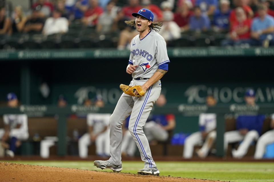 Toronto Blue Jays starting pitcher Kevin Gausman celebrates after striking out Texas Rangers' Adolis Garcia, leaving runners on first and second, in the fifth inning of a baseball game in Arlington, Texas, Saturday, Sept. 10, 2022. (AP Photo/Tony Gutierrez)