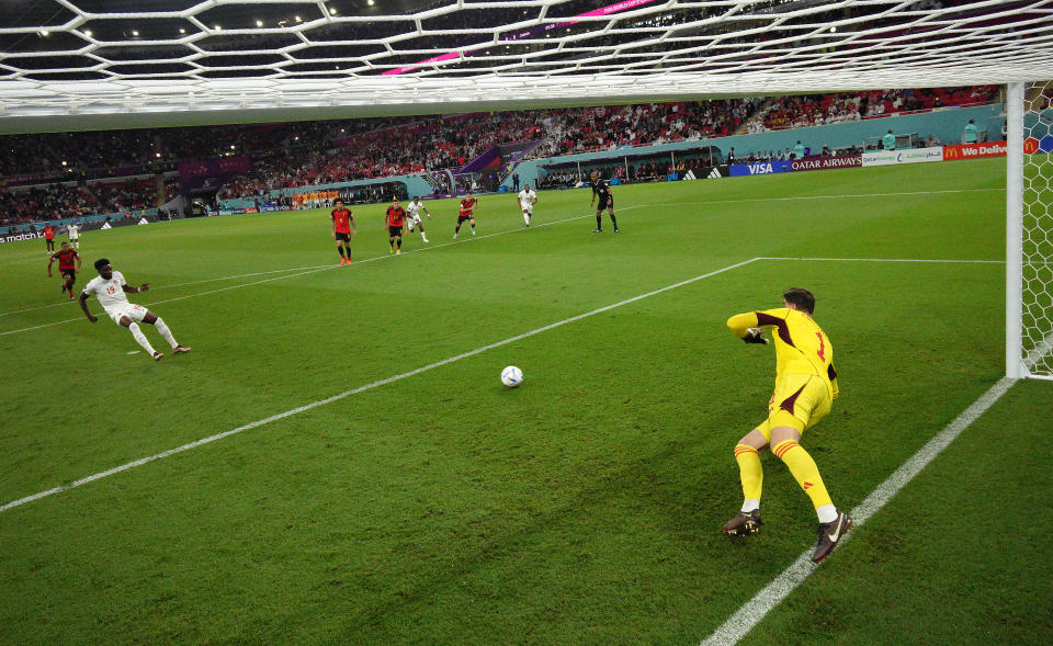 DOHA, QATAR - NOVEMBER 23:   (EDITORS NOTE: In this photo taken from a remote camera from inside the goal) Thibaut Courtois of Belgium saves the penalty taken by Alphonso Davies of Canada during the FIFA World Cup Qatar 2022 Group F match between Belgium and Canada at Ahmad Bin Ali Stadium on November 23, 2022 in Doha, Qatar. (Photo by Julian Finney/Getty Images)