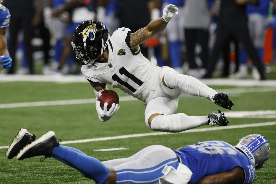 Jacksonville Jaguars wide receiver Parker Washington (11) falls over Detroit Lions defensive end Isaiah Buggs (96) during the second half of a preseason NFL football game, Saturday, Aug. 19, 2023, in Detroit. (AP Photo/Duane Burleson)