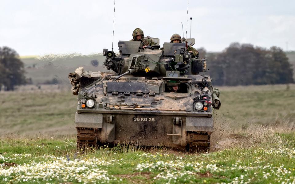 A British Army Warrior Infantry Fighting Vehicle on a military exercise on the Salisbury Plain Training Area in Wiltshire,