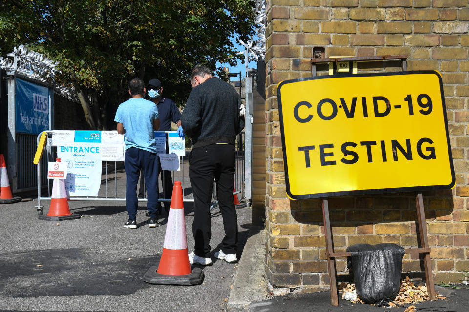 People queue up outside a coronavirus testing centre offering walk-in appointments in east London. (Photo by Kirsty O'Connor/PA Images via Getty Images)