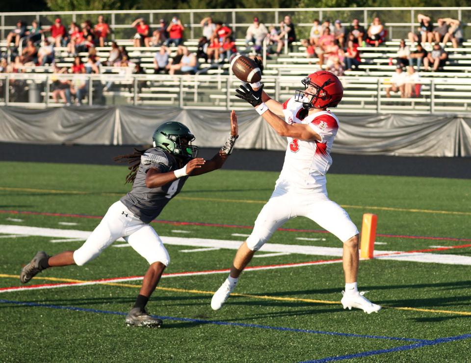North Hagerstown's Ryder Johnston catches a pass from Luke Kercheval for a touchdown during the Hubs' 38-27 season-opening win over Tuscarora.