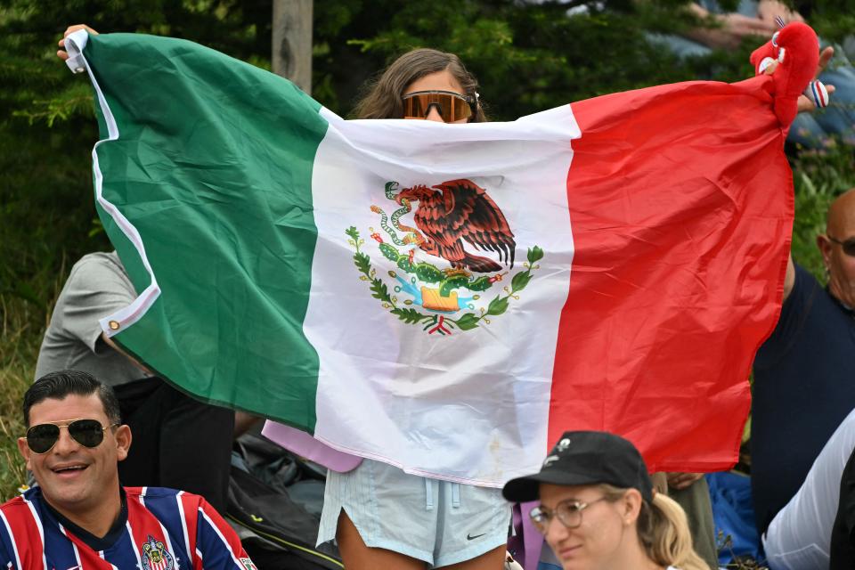 A Mexico's supporter waves a flag before the start of the opening ceremony of the Paris 2024 Olympic Games in Paris on July 26, 2024. (Photo by Miguel MEDINA / AFP) (Photo by MIGUEL MEDINA/AFP via Getty Images)