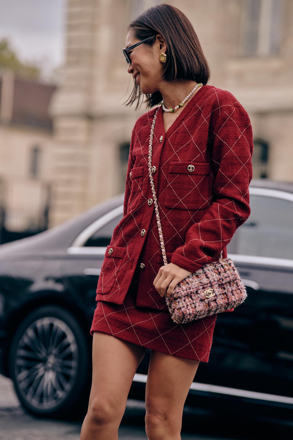 Fashion week spring/summer 2024 attendee wearing red chanel skirt and sweater