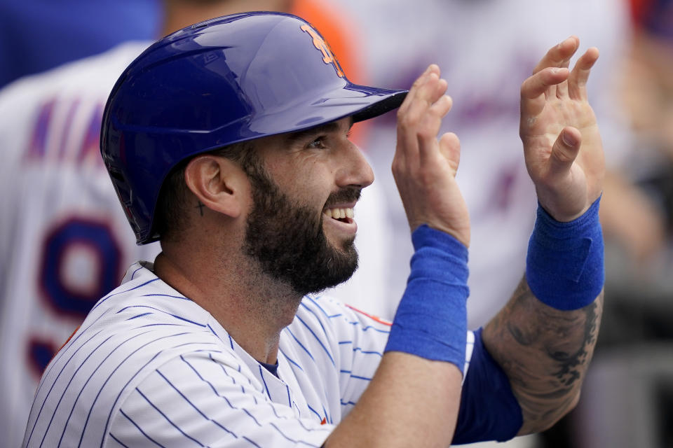 New York Mets' Tomas Nido celebrates in the dugout after scoring on an RBI sacrifice fly by Francisco Lindor off Washington Nationals relief pitcher Kyle Finnegan in the seventh inning of a baseball game, Wednesday, June 1, 2022, in New York. (AP Photo/John Minchillo)