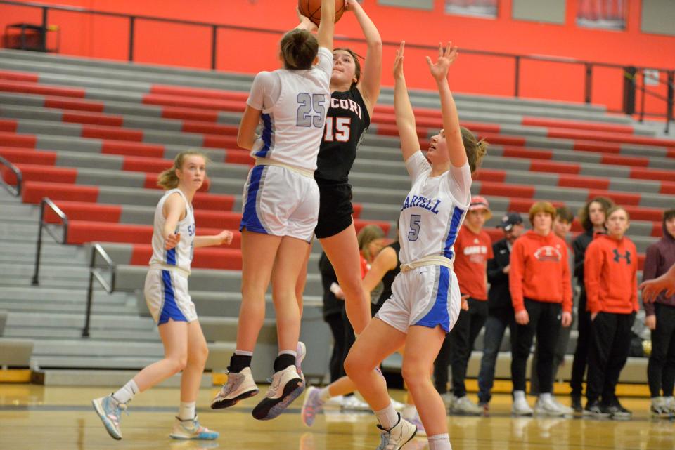 ROCORI's Madison Terres goes up for a jump shot, while Sartell's Chloe Turner tries to block it as ROCORI battles Sartell at ROCORI High School on Tuesday, Jan. 25, 2022. 