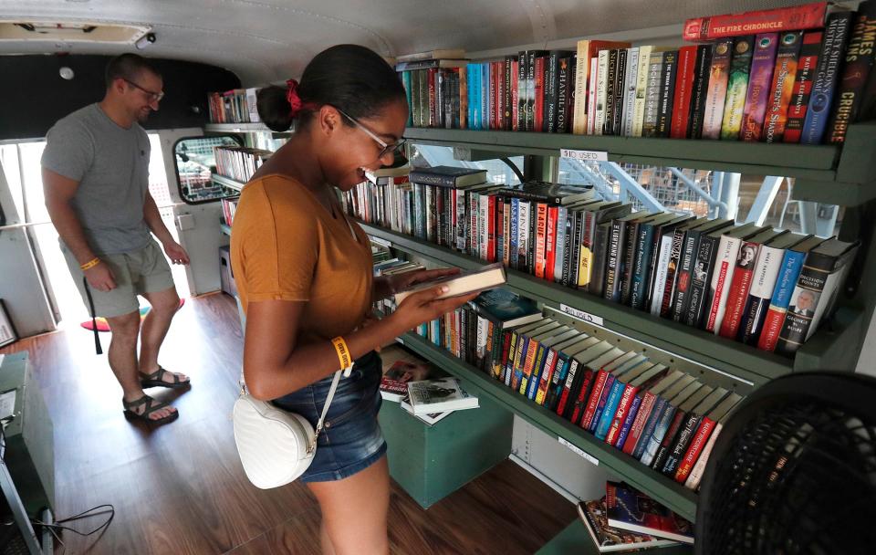 Christopher Webb and Rhonda Faison browse through the selection of books available on the Book Bus during a stop at Starland Yard.