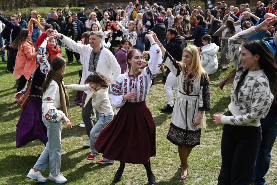 People dance during the Orthodox Easter celebrations in the western Ukrainian city of Lviv, on April 16, 2023. Easter is the most sacred holiday in the Orthodox calendar. Ukrainian President Volodymyr Zelensky congratulated Ukraine's Orthodox believers saying "We celebrate the Easter holiday with unshakable faith in our victory." (Yuriy Dyachyshyn/AFP via Getty Images)