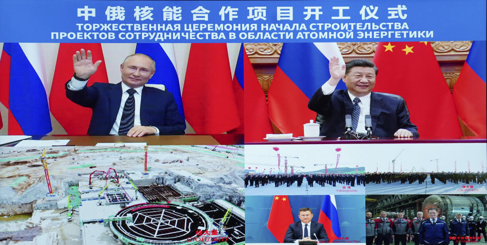Chinese President Xi Jinping and his Russian counterpart Vladimir Putin are displayed on a screen as they witness the ground-breaking ceremony of a bilateral nuclear energy cooperation project, Tianwan nuclear power plant and Xudapu nuclear power plant, via video link, in Beijing, Wednesday, May 19, 2021. The Chinese leader and his Russian counterpart joined in a videoconference to initiate a series of nuclear energy projects, an event intended to display warming ties between two nations that have paired-up as the chief geopolitical rivals to the United States. (Huang Jingwen/Xinhua via AP)